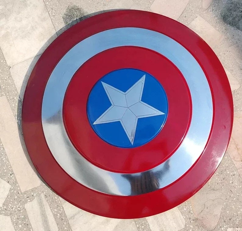 May include: A red, white, and blue Captain America shield with a silver rim. The shield has a five-pointed star in the center.