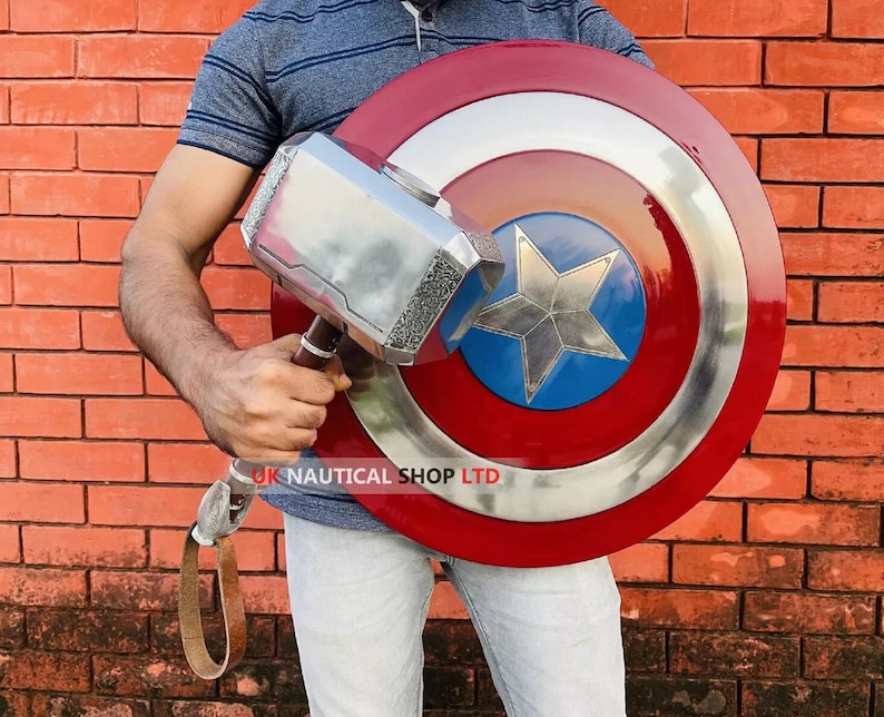 May include: A person holding a silver Thor's hammer and a red, white, and blue Captain America shield. The shield has a star in the center.