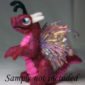 May include: A small, pink and red felt dragon with iridescent wings. The dragon has a long, thin tail and a small, pointed head with a single horn.