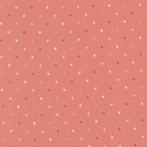 May include: Coral fabric with a repeating pattern of small, evenly spaced polka dots. The dots vary in color, including white, light coral, and darker coral shades. The fabric has a subtle texture, suggesting it may be cotton or a similar material.