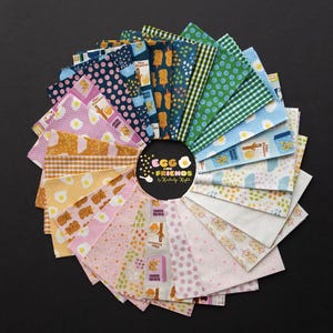 May include: A circular arrangement of fabric squares in various patterns and colors, including polka dots, gingham, and food-themed prints. The fabrics feature images of eggs, bananas, and other breakfast items. The center of the arrangement displays the text "Egg and Friends".