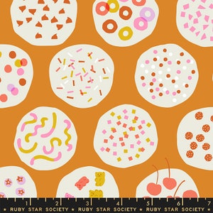 May include: A repeating pattern of colorful, whimsical cookies on a burnt orange background. The cookies are decorated with sprinkles, candies, and other fun designs.