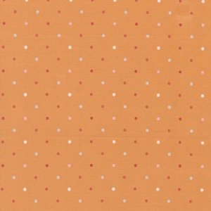 May include: Close-up of orange fabric with a repeating pattern of small polka dots. The dots are in shades of red, pink, and white, evenly spaced across the surface. The fabric has a textured appearance.