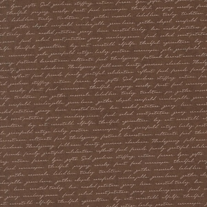 May include: Brown fabric with a repeating pattern of handwritten text in a lighter brown color. The text appears to be a list of words related to a harvest or Thanksgiving theme.
