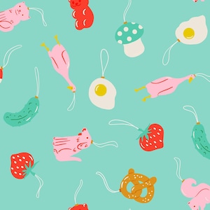 May include: A repeating pattern on a light teal background featuring various hanging ornaments including red strawberries, green pickles, pink cats, red and white mushrooms, fried eggs, brown pretzels, yellow gummy bears, and pink chickens.