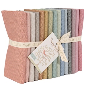 May include: A bundle of fabric squares in various pastel colors, tied with a ribbon. The fabric has a dotted pattern. A tag with a tree and bird illustration reads "Poppy Seed Basics" and "Tilda".