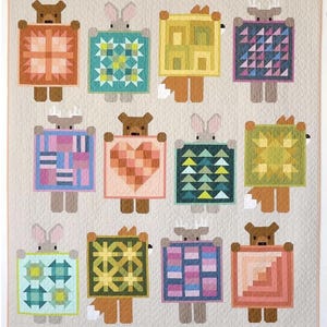 May include: A colorful patchwork quilt featuring whimsical animal figures holding geometric designs. The quilt showcases a variety of patterns, including hearts, triangles, and squares, in shades of orange, blue, green, and pink. The quilt is made of fabric.