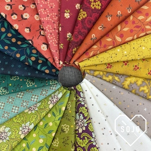 May include: A circular arrangement of various fabric swatches in shades of red, orange, yellow, green, and blue. Each swatch features a different floral or botanical pattern. The fabrics are fanned out from a central dark gray circle.