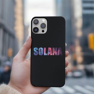 May include: Black phone case with a white outline of the word "SOLANA" in a colorful, abstract design.
