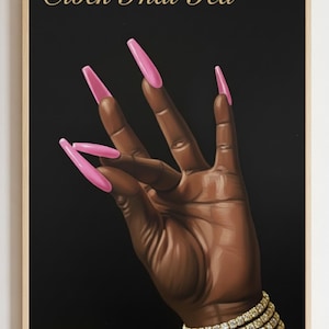May include: A framed print featuring a hand with long, pink fingernails against a black background. The wrist is adorned with a gold bracelet. The words "Clock That Tea" are written in gold script at the top.