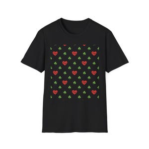 May include: Black t-shirt with a repeating pattern of red hearts and green shamrocks. Each heart contains the word "Papa" in white script. The shirt is a classic crew neck style.
