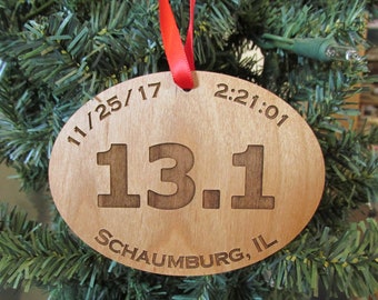 May include: A wooden oval ornament with the text "11/25/17 2:21:01 13.1 Schaumburg, IL" engraved on it.