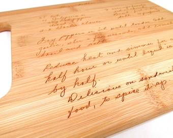 May include: A close-up of a bamboo cutting board with a handwritten recipe for "Dry Pepper" engraved on the surface. The recipe includes instructions to "Reduce heat and simmer for about half hour or until liquid is by half. Delicious on sandwiches, food to spice it up."