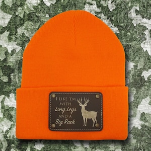 May include: Orange beanie with a brown leather patch that says "I like 'em with long legs and a big rack" with a silhouette of a deer inside the patch.