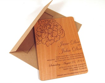 May include: A wooden wedding invitation with a floral design and the text "Jane Doe and John Doe" with the wedding date "Saturday, August 23, 2014".