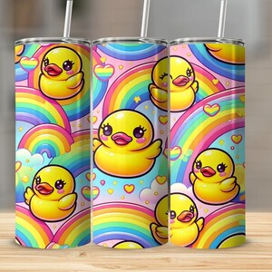 May include: A stainless steel tumbler with a colorful design featuring yellow rubber ducks and rainbows. The tumbler has a pink background with white hearts and stars.