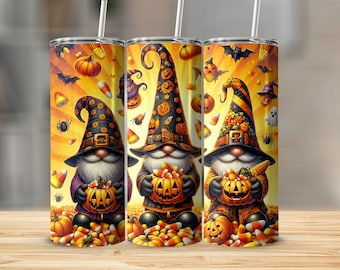 May include: Three Halloween-themed tumblers with gnome illustrations. Each gnome wears a pointed hat and holds a carved pumpkin filled with candy corn. The background features pumpkins, bats, and spiders. The tumblers have a straw.