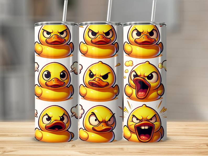 May include: A set of three stainless steel tumblers with a white background and a pattern of yellow rubber duckies with different facial expressions. The tumblers are all the same size and shape.
