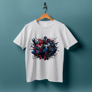 May include: White t-shirt with a graphic print of Spider-Man and Venom in a black and red color scheme.