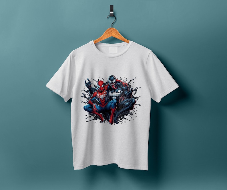 May include: White t-shirt with a graphic print of Spider-Man and Venom in a black and red color scheme.