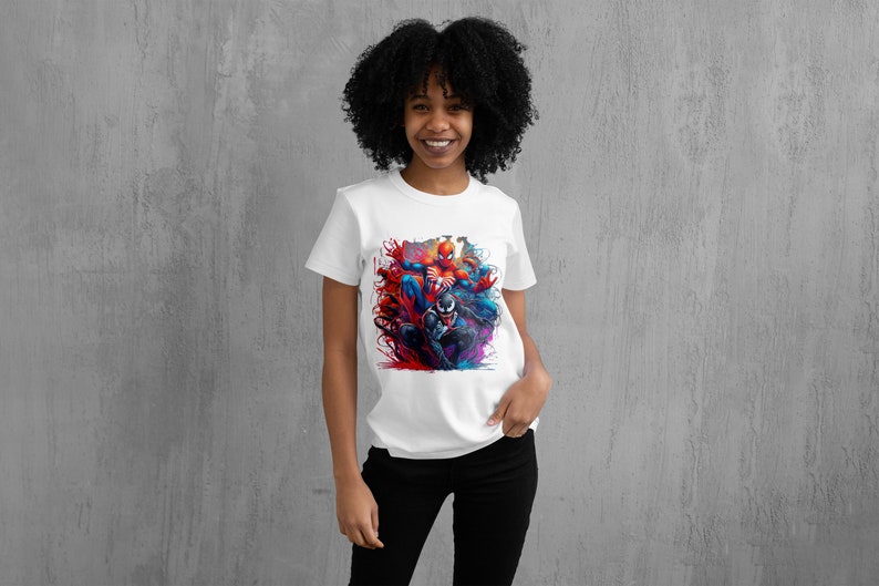 May include: White t-shirt with a colorful graphic print of Spider-Man and Venom fighting. The graphic is in a dynamic pose with splashes of red, blue, and purple paint.