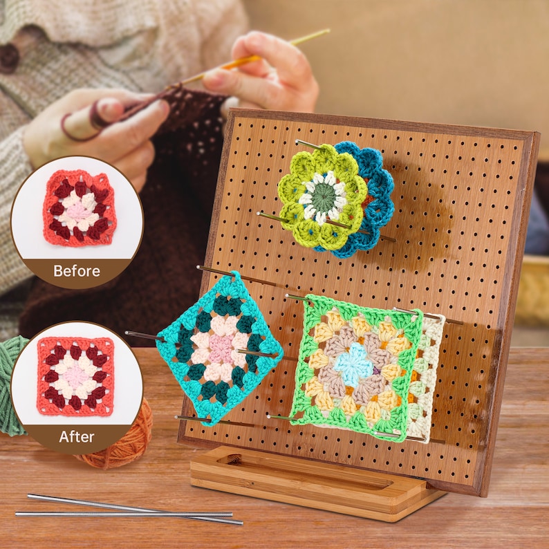 May include: A wooden crochet project display stand with pegs to hold crochet squares. The stand has a brown finish and a pegboard design. There are four crochet squares on the stand, each with a different colour pattern. The squares are made with a variety of colours, including green, blue, pink, and yellow. The stand is on a wooden table.