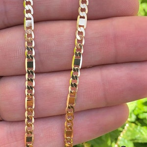 May include: A gold chain necklace with a curb link design. The chain is made of solid gold and has a polished finish.