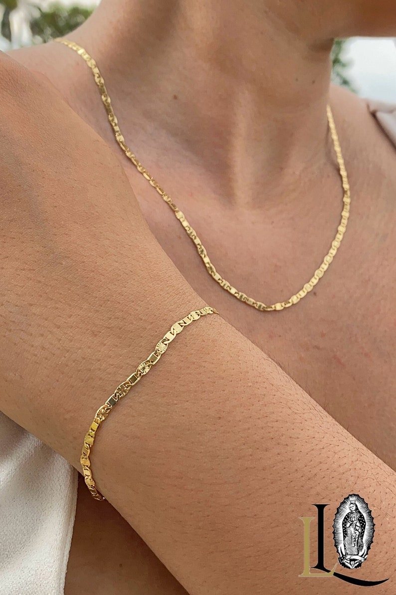 May include: A gold chain necklace and bracelet with a delicate, textured design. The necklace is longer than the bracelet.
