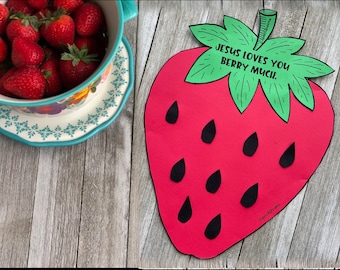 May include: A red paper strawberry with black seeds and a green paper leaf with the text "Jesus loves you berry much."