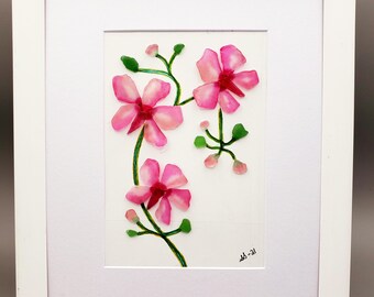 May include: Framed artwork featuring a pink flower arrangement made of sea glass. The flowers are arranged on a green stem with leaves. The artwork is signed "sb - 21" in the bottom right corner.