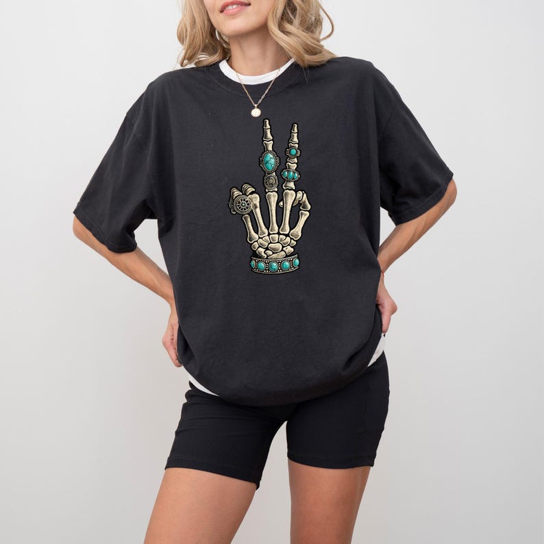 a woman wearing a black shirt with a hand print on it
