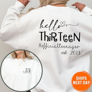A white sweatshirt with black text and graphics on the back.