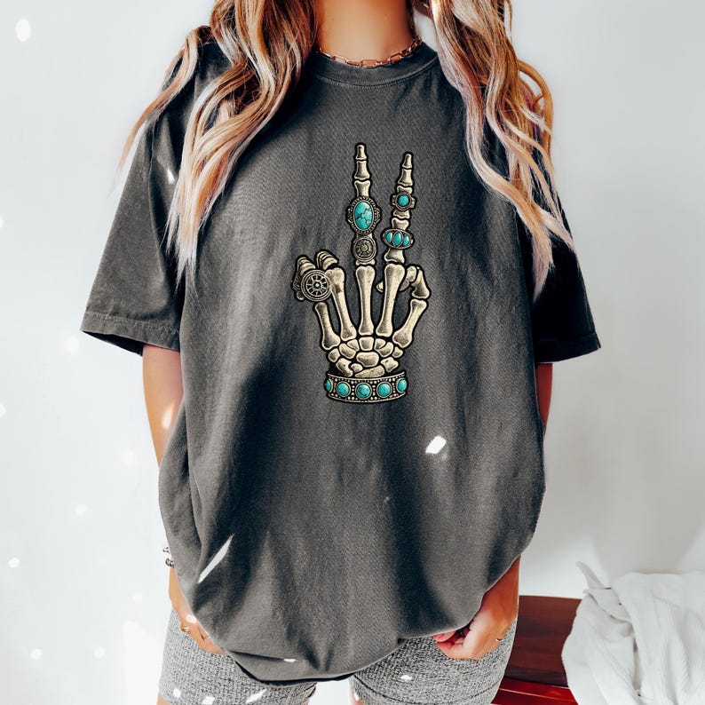 a woman wearing a t - shirt with a skeleton hand on it