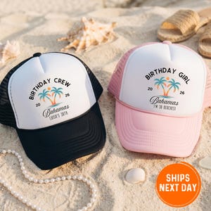 May include: Two trucker hats with white fronts and mesh backs. One is black with "BIRTHDAY CREW" and "Bahamas" text, the other is pink with "BIRTHDAY GIRL" and "Bahamas" text. Both have a palm tree graphic.
