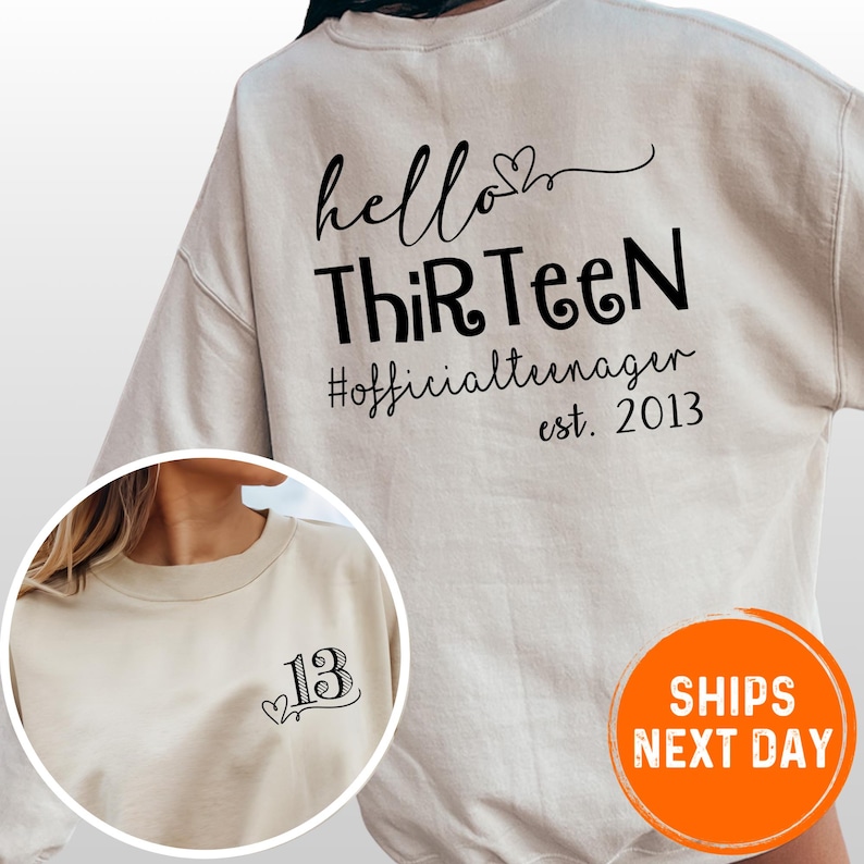 A white sweatshirt with black text and a number 13 printed on it.
