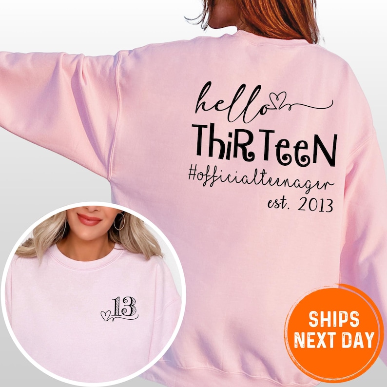 A woman wearing a pink sweatshirt with text printed on the back.