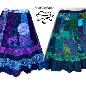 May include: Two patchwork skirts with different designs. The skirt on the left has a purple and blue color scheme with a moon and wolf design. The skirt on the right has a green and blue color scheme with a butterfly design.