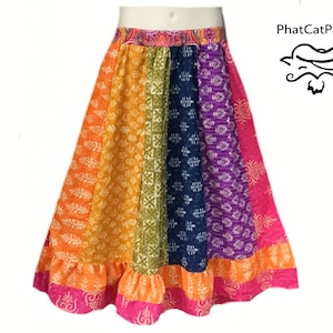 May include: A colorful patchwork skirt with a ruffled hem. The skirt is made of different fabrics with floral and geometric patterns in shades of orange, yellow, green, blue, purple, and pink.