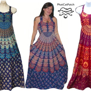May include: Three maxi dresses with different mandala patterns. The dresses are sleeveless and have a halter neck style. The dress on the left is blue with a teal and gold mandala pattern. The middle dress is blue with a pink, orange, and teal mandala pattern. The dress on the right is red with an orange and gold mandala pattern.