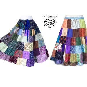 May include: Two patchwork skirts in a variety of colors, including purple, blue, green, and brown. The skirts are made of different fabrics and have a tiered design. The skirts are both long and flowy.