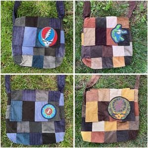 May include: Four corduroy patchwork shoulder bags in various colors, including blue, brown, and tan. Each bag features a different patch with a skull and lightning bolt design or a turtle playing a guitar. The bags have long straps.