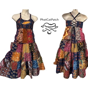 May include: A patchwork halter dress with a tiered skirt. The dress features a variety of colorful fabric patterns, including floral and geometric designs. The front of the dress has a lightning bolt design. The back of the dress has a criss-cross lace-up design.