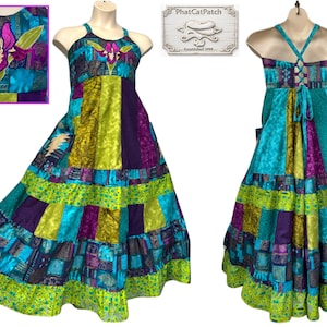 May include: A patchwork maxi dress with a halter neckline, featuring a vibrant mix of teal, purple, green, and gold fabrics. The bodice is adorned with an embroidered floral design. The back of the dress has a lace-up detail.