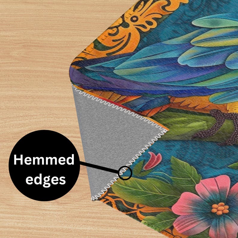 May include: A colorful rug with a floral design and a blue bird pattern. The rug has a gray backing and is hemmed around the edges.