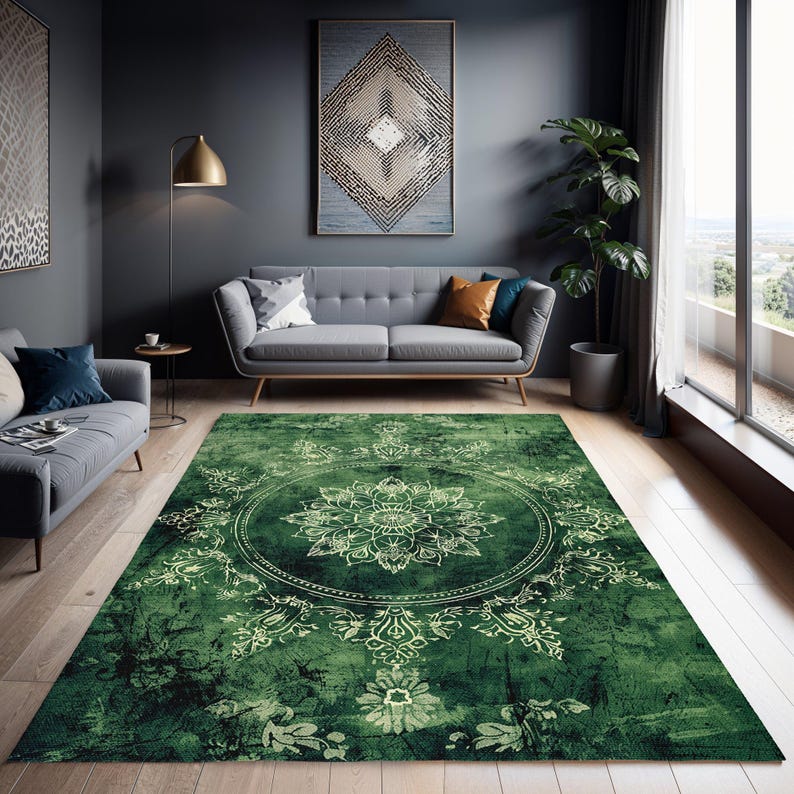 May include: A green area rug with a white mandala design. The rug has a distressed, vintage look. The rug is in a living room setting with a gray sofa and a green plant.