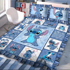 May include: A blue and white quilt set featuring the character Stitch from Lilo & Stitch. The quilt has a central image of Stitch surrounded by squares with different Stitch images and text. Includes two pillowcases.