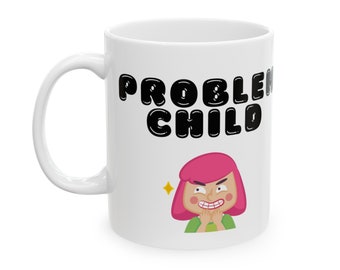 May include: White ceramic mug featuring a black graphic that reads "PROBLEM CHILD" and a cartoon illustration of a girl with pink hair and a mischievous expression.