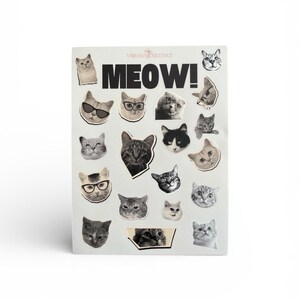 May include: A rectangular card with a collage of cat faces. The word "MEOW!" is printed in bold black letters. The card has the text "VIBRANT EXISTENCE" at the top. The cat faces are in black and white.