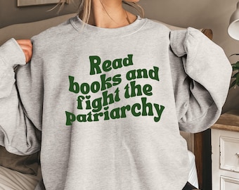 May include: Grey sweatshirt with the text "Read books and fight the patriarchy" in green.