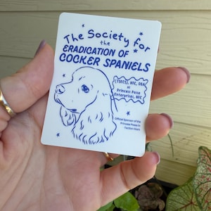May include: A white rectangular sticker featuring a blue line drawing of a cocker spaniel and the text The Society for the ERADICATION OF COCKER SPANIELS, (TSECS), NFC, DBA as Princess Posse Enterprises, NFC, Official Sponsor of the Princess Posse.